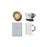 A stack of filters, blue bottle dripper, instructional booklet, and carafe.